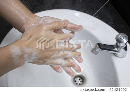A Man Washing Hand with a Soap to Kill Bacteria 63421992