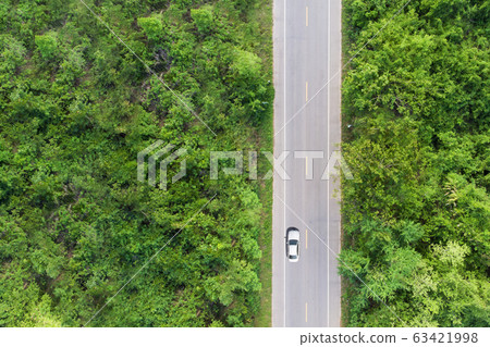 Aerial view of the road passing the forest with a Aerial view of the road passing the forest with a 63421998