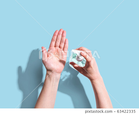 Applying sanitizer gel Applying sanitizer gel 63422335