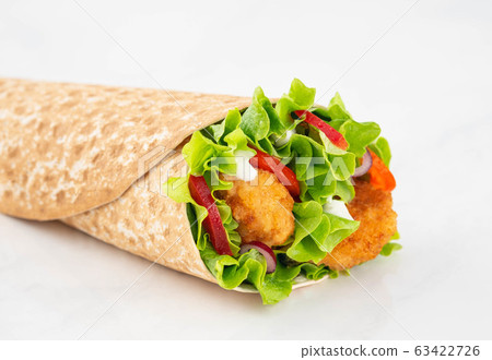 Wrap with fried chicken and vegetables isolated on a white background 63422726