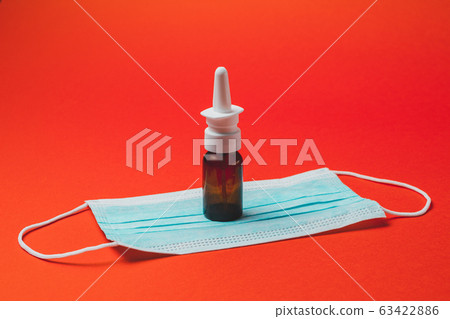 On a red background, a bottle for runny nose and 63422886