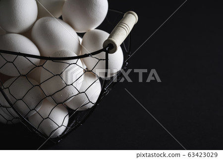 Organic eggs in wire basket close-up Organic eggs in wire basket close-up 63423029