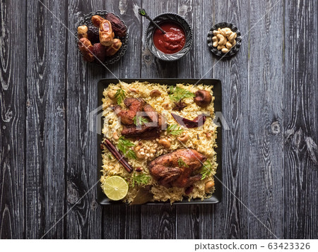 Festive dish with baked chicken and rice. 63423326