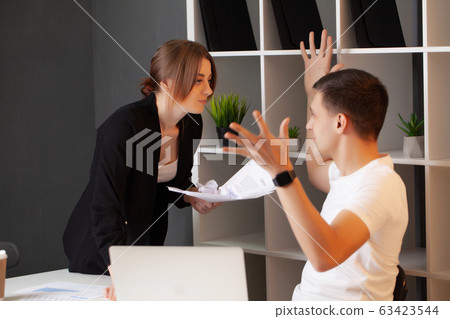 Angry woman has a conflict with the manager of the company Angry woman has a conflict with the manager of the company 63423544