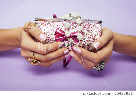 little girl stuff for princess, woman hands holding small cute handbag with jewelry and manicure, luxury lifestyle concept little girl stuff for princess, woman hands holding small cute handbag with jewelry and manicure, luxury lifestyle concept 63423938