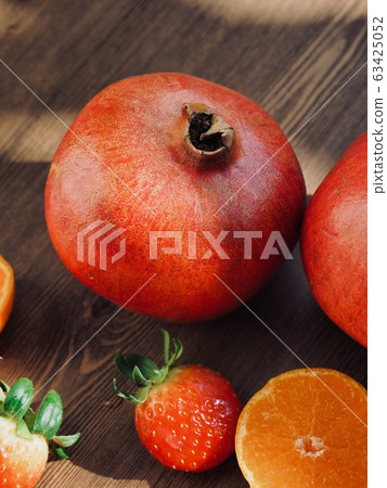 Fresh organic fruits strawberries, tangerines, pomegranates 63425052