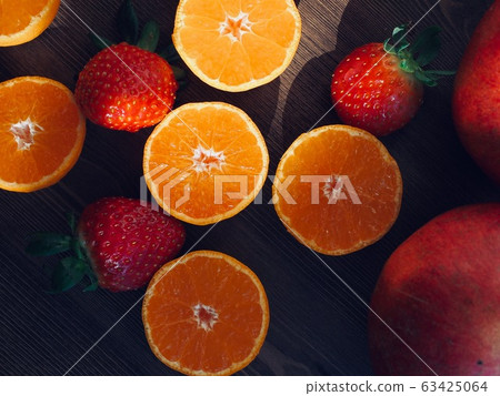 Fresh organic fruits strawberries, tangerines, pomegranates 63425064