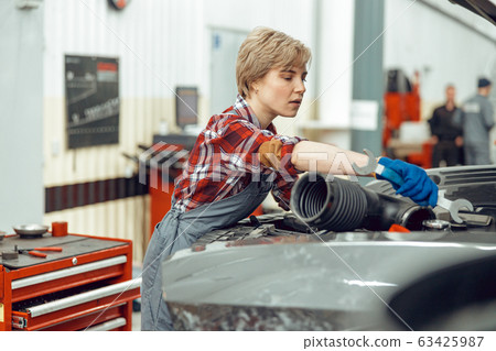Young woman working at a service station 63425987
