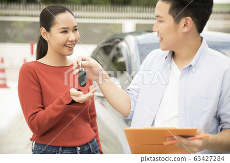 A woman receiving a skills training at a driving school 63427284