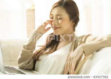 A woman who operates a personal computer at home A woman who operates a personal computer at home 63427362