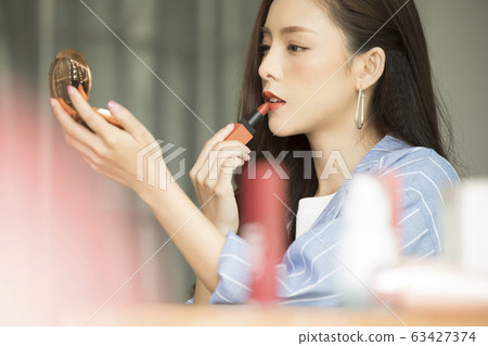 Young woman wearing a jacket to make up Young woman wearing a jacket to make up 63427374