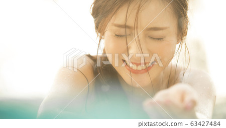 Woman relaxing at resort Woman relaxing at resort 63427484