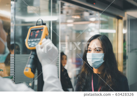 People waiting for temperature check by thermoscan People waiting for temperature check by thermoscan 63428326