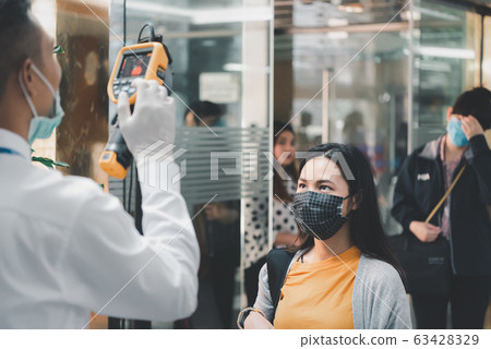 People waiting for temperature check by thermoscan People waiting for temperature check by thermoscan 63428329