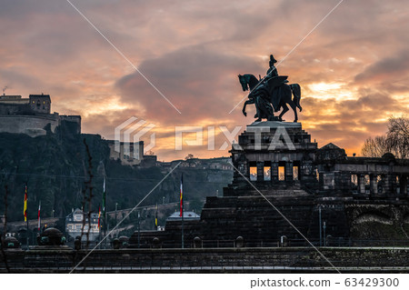 Colorful Sunrise burning sky Koblenz City historic monument German Corner where river rhine and mosele flow together 63429300