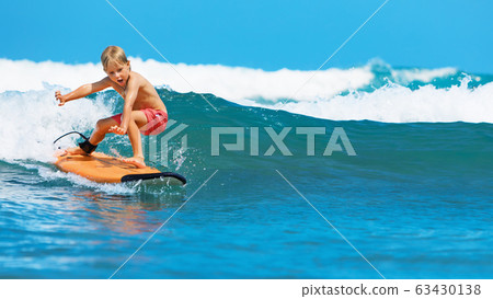 Young surfer learn to ride on surfboard on sea Young surfer learn to ride on surfboard on sea 63430138