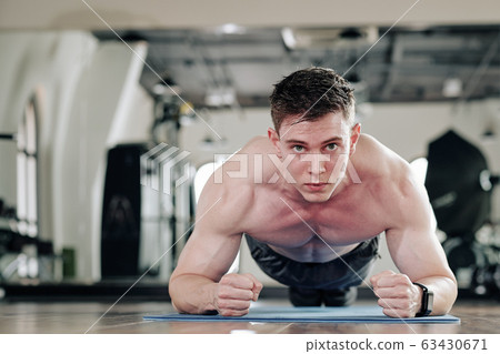 Shirtless man in plank position 63430671