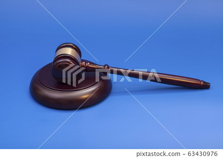 Wooden judge gavel and soundboard isolated on blue Wooden judge gavel and soundboard isolated on blue 63430976