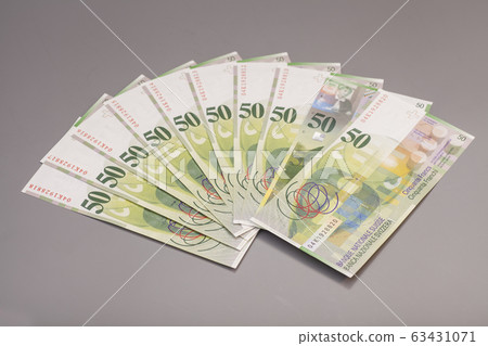 50 Swiss Franc bills isolated on gray background 63431071