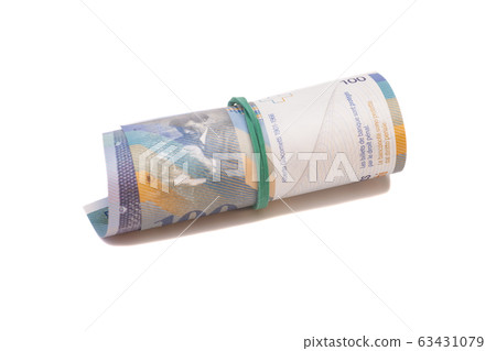 Swiss francs in a roll on white background 63431079