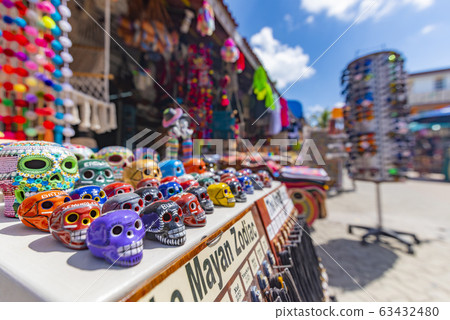 Classic colorful skulls of Mexican souvenirs 63432480