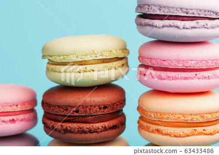 Macaroni cookies of different colors are arranged 63433486