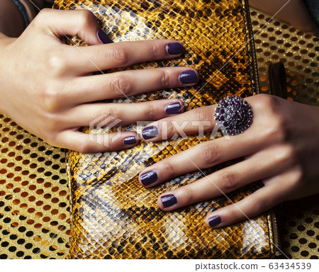 pretty fingers of african american woman holding money closeup with purse, luxury jewellery on python clutch, cash for gifts pretty fingers of african american woman holding money closeup with purse, luxury jewellery on python clutch, cash for gifts 63434539
