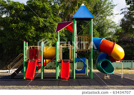 Colorful playground activities in public park . Urban neighborhood childhood concept. Colorful playground activities in public park . Urban neighborhood childhood concept. 63434707