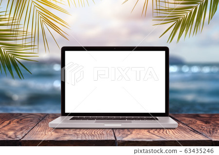 Notebook mock-up display on wooden table against sea background. 63435246