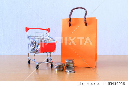 Cart supermarket and orange paper bag on wood Cart supermarket and orange paper bag on wood 63436038