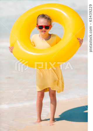 Adorable little girl having fun on the beach Adorable little girl having fun on the beach 63439229