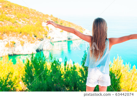 Little girl on vacation travel background beautiful landscape Little girl on vacation travel background beautiful landscape 63442074