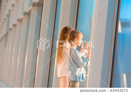 Little kid in airport waiting for boarding Little kid in airport waiting for boarding 63443073