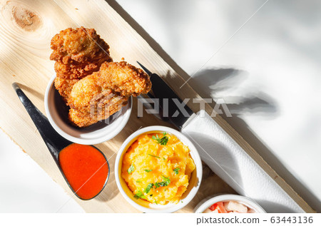 Breaded and herbed chicken breast fillet served Breaded and herbed chicken breast fillet served 63443136