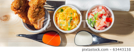 Breaded and herbed chicken breast fillet served 63443138