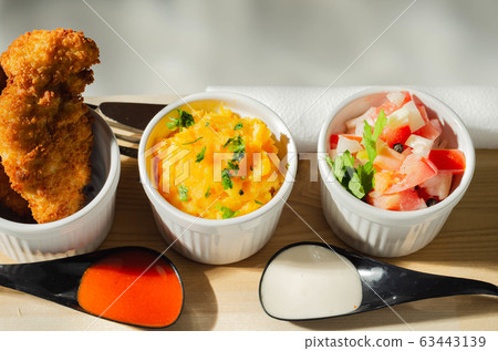 Breaded and herbed chicken breast fillet served Breaded and herbed chicken breast fillet served 63443139