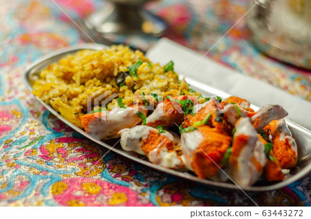 Pieces of cooked marinated chicken breast in an Pieces of cooked marinated chicken breast in an 63443272