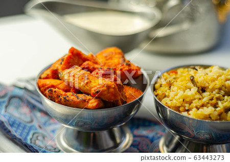 Pieces of cooked marinated chicken breast in an 63443273