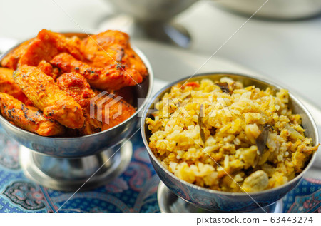 Pieces of cooked marinated chicken breast in an Pieces of cooked marinated chicken breast in an 63443274