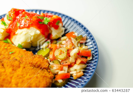 Spicy chilli chicken fillets served with mashed 63443287