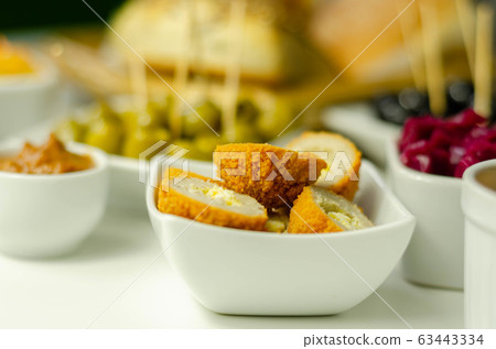Savory mini scotch eggs in white ceramic bowl, Savory mini scotch eggs in white ceramic bowl, 63443334