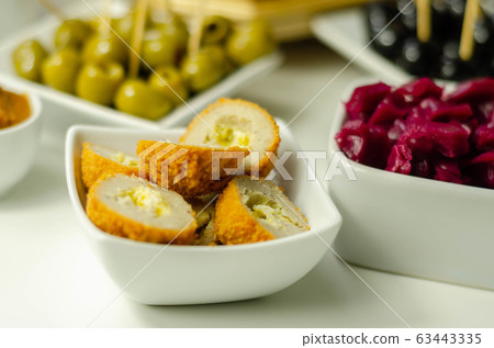 Savory mini scotch eggs in white ceramic bowl, 63443335