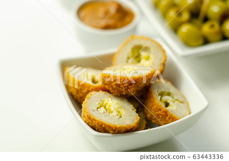 Savory mini scotch eggs in white ceramic bowl, 63443336