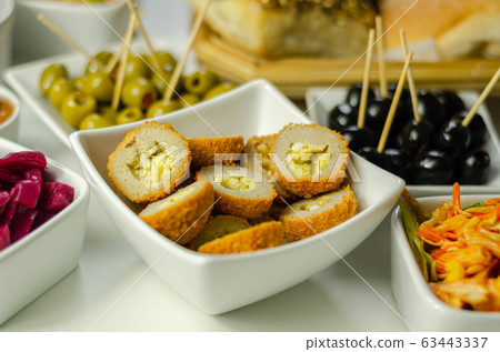 Savory mini scotch eggs in white ceramic bowl, Savory mini scotch eggs in white ceramic bowl, 63443337
