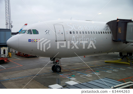 COPENHAGEN, DENMARK - NOV 24th, 2018: SAS Airbus A340 at the departure gate of Copenhagen Kastrup airport before departing to USA COPENHAGEN, DENMARK - NOV 24th, 2018: SAS Airbus A340 at the departure gate of Copenhagen Kastrup airport before departing to USA 63444263