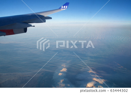 SAN FRANCISCO, CALIFORNIA, UNITED STATES - NOV 24th, 2018: Greenland view from airplane, frozen mountains or glaciers with wing view 63444302