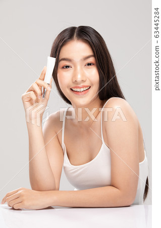 Beautiful Asian young woman touching soft cheek smile with clean fresh skin 63445284