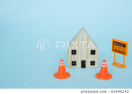 Prohibition sign with wooden house model on blue background Prohibition sign with wooden house model on blue background 63446242