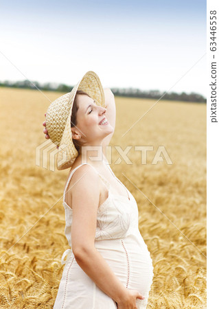 Young pretty pregnant woman outdoors on sunset in Young pretty pregnant woman outdoors on sunset in 63446558