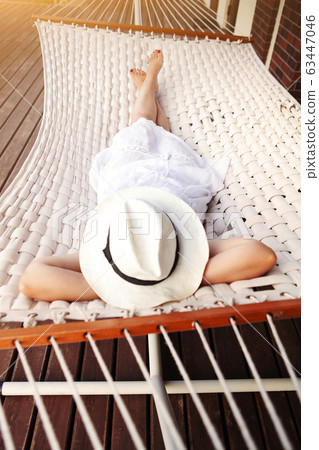 Woman lying in hammock 63447046